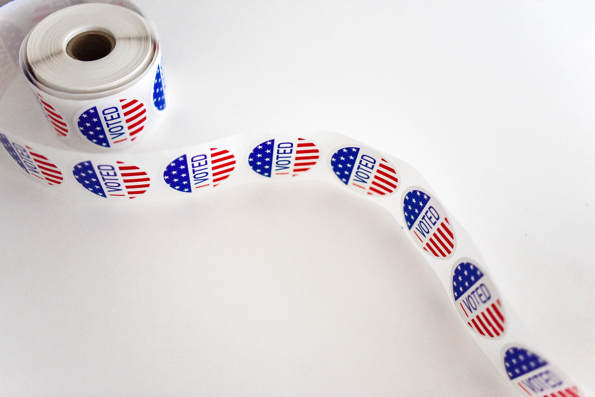 A roll of "I Voted" stickers on a white background.
